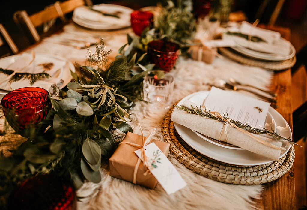 an image of a table set for dinner with Christmas centrepiece