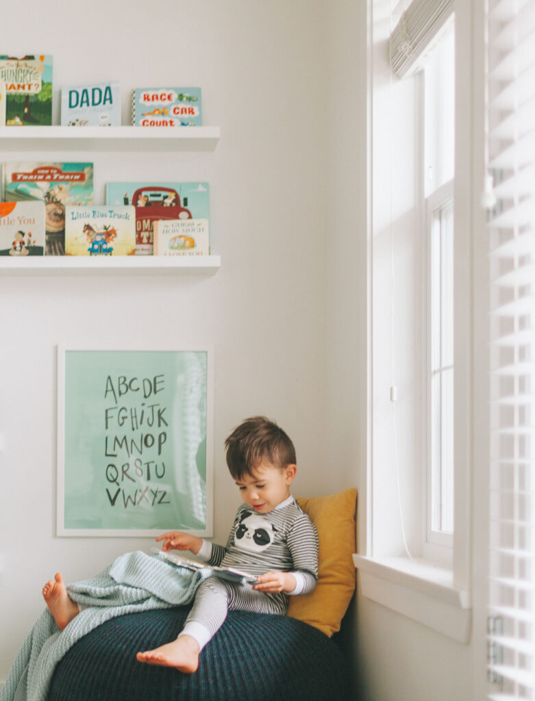 image of toddler reading in a kids reading corner 