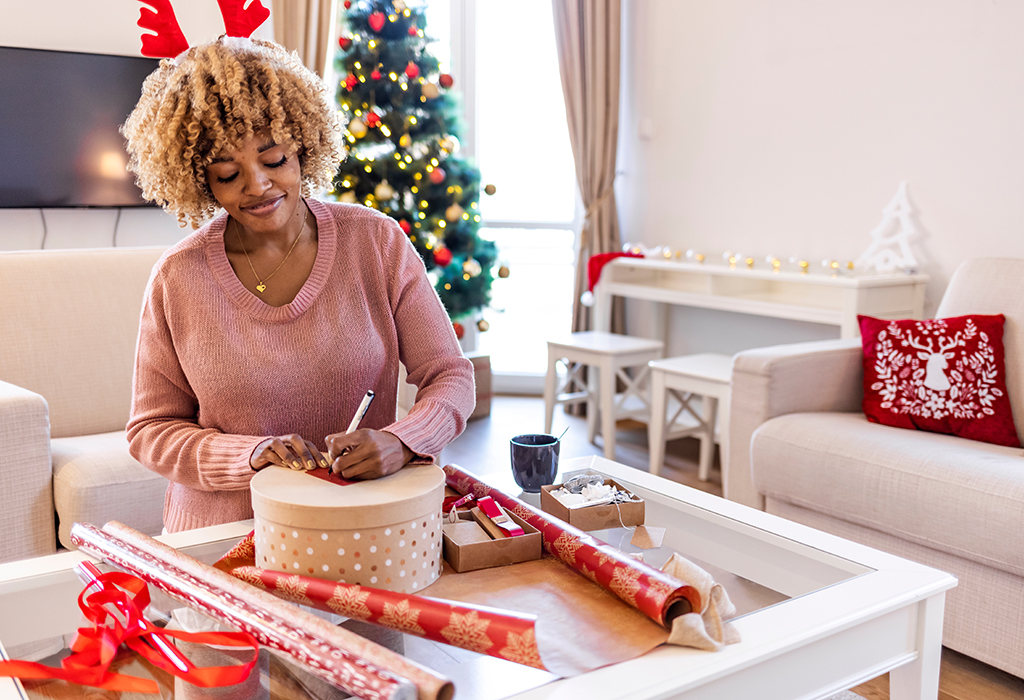 photo of woman wrapping presents for Christmas 