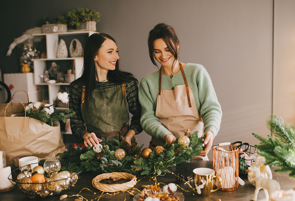 a photo of two woman making wreaths for Christmas
