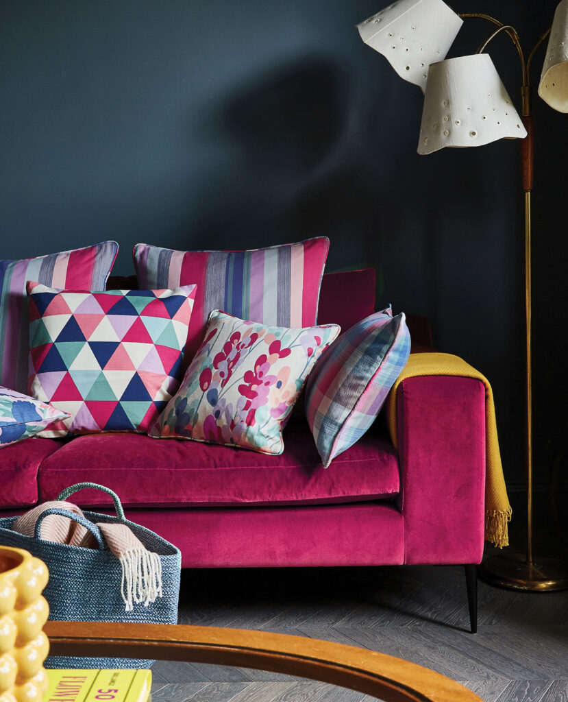 photo of a living room with hot pink sofa and yellow cushions 