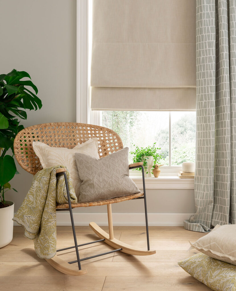 image of chair in room next to window and roman blind