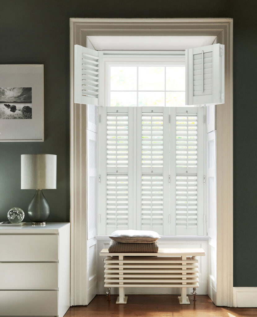 image of green and white room and big window with white shutter blinds 