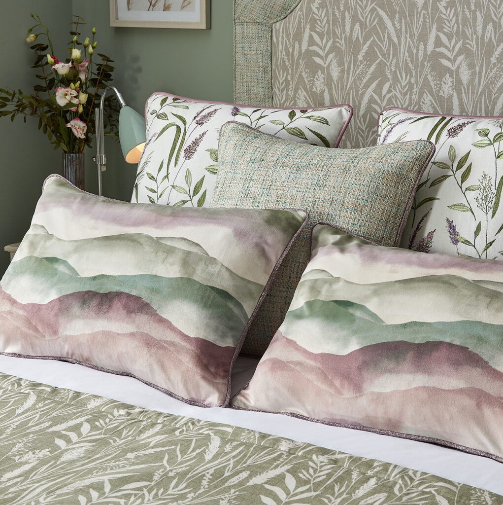 close up image of a green bed in a bedroom with cushions on top