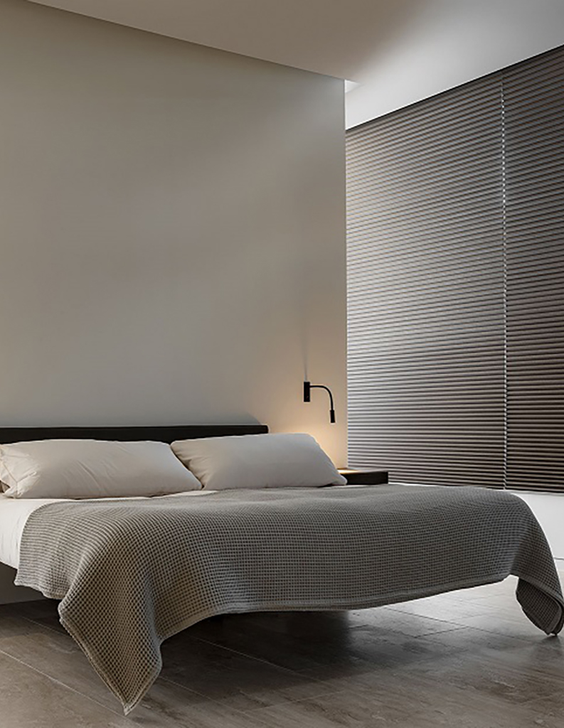 bedroom room set with honeycomb blinds to insulate windows.