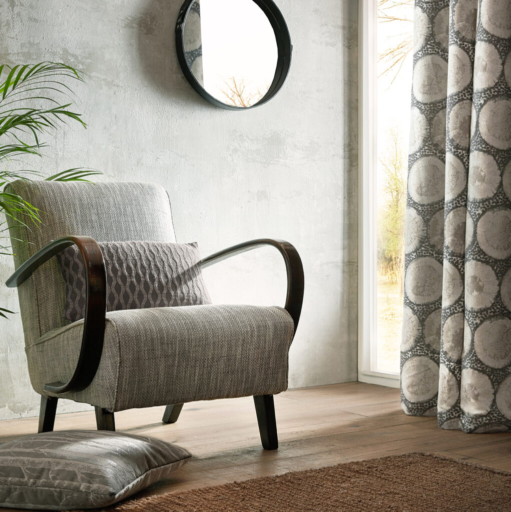 close up image of mushroom coloured chair next o window 