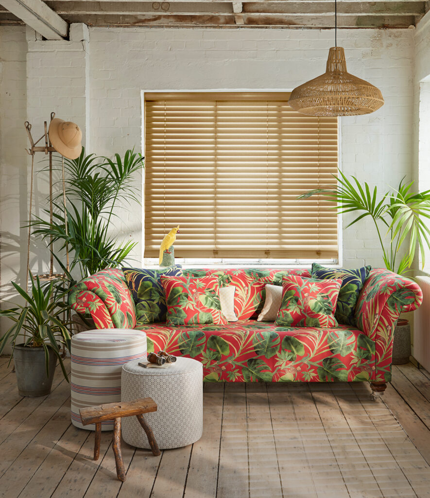 photo of bright floral sofa in wooden themed room