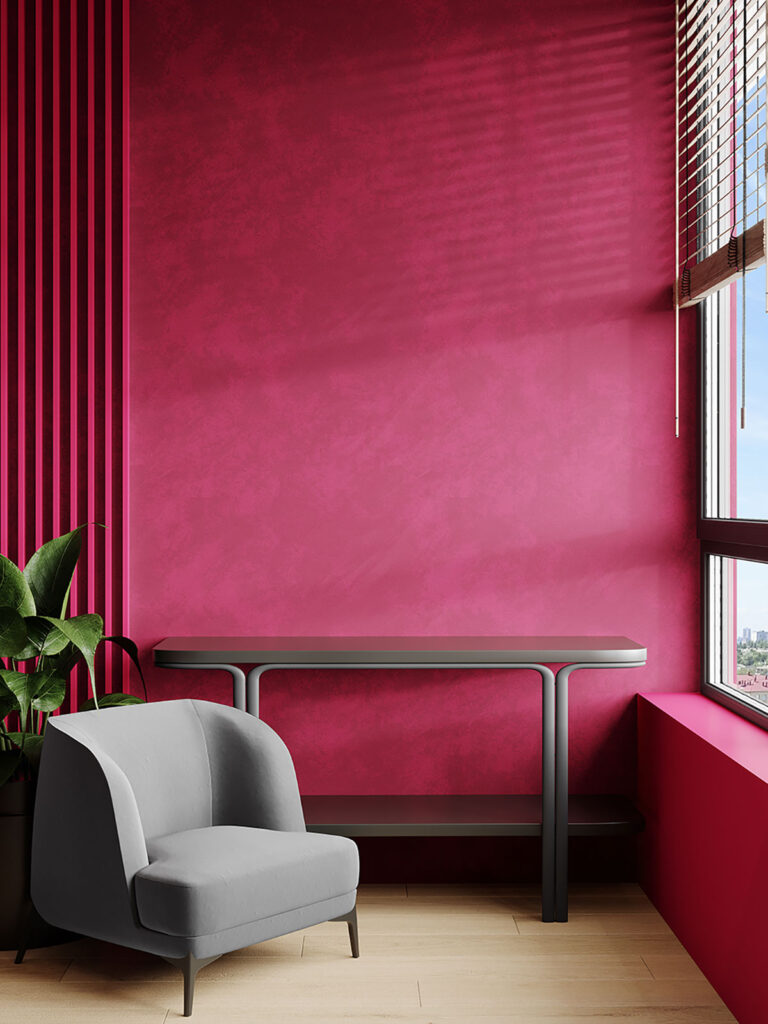 image of a berry red room with a grey chair and wooden blinds 