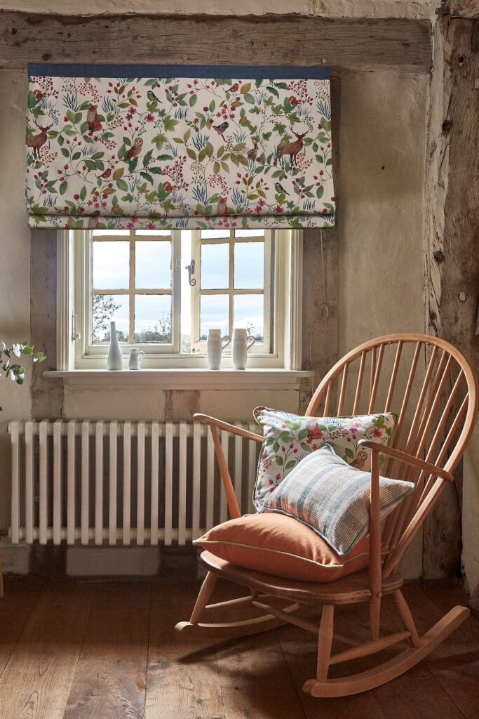 A statement Roman blind in a rustic living room.