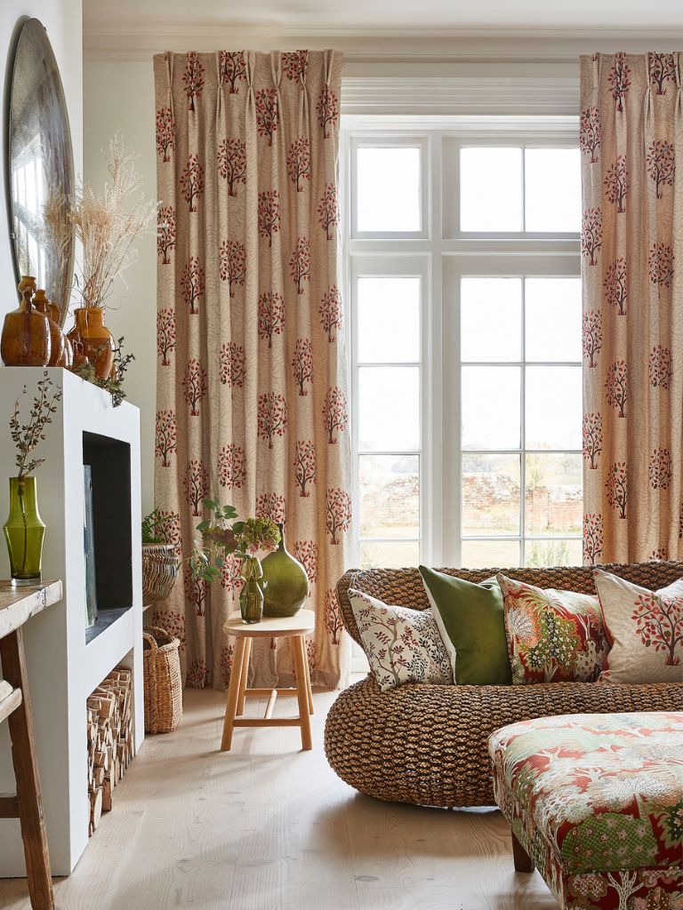 An autumnal living room with patterned curtains