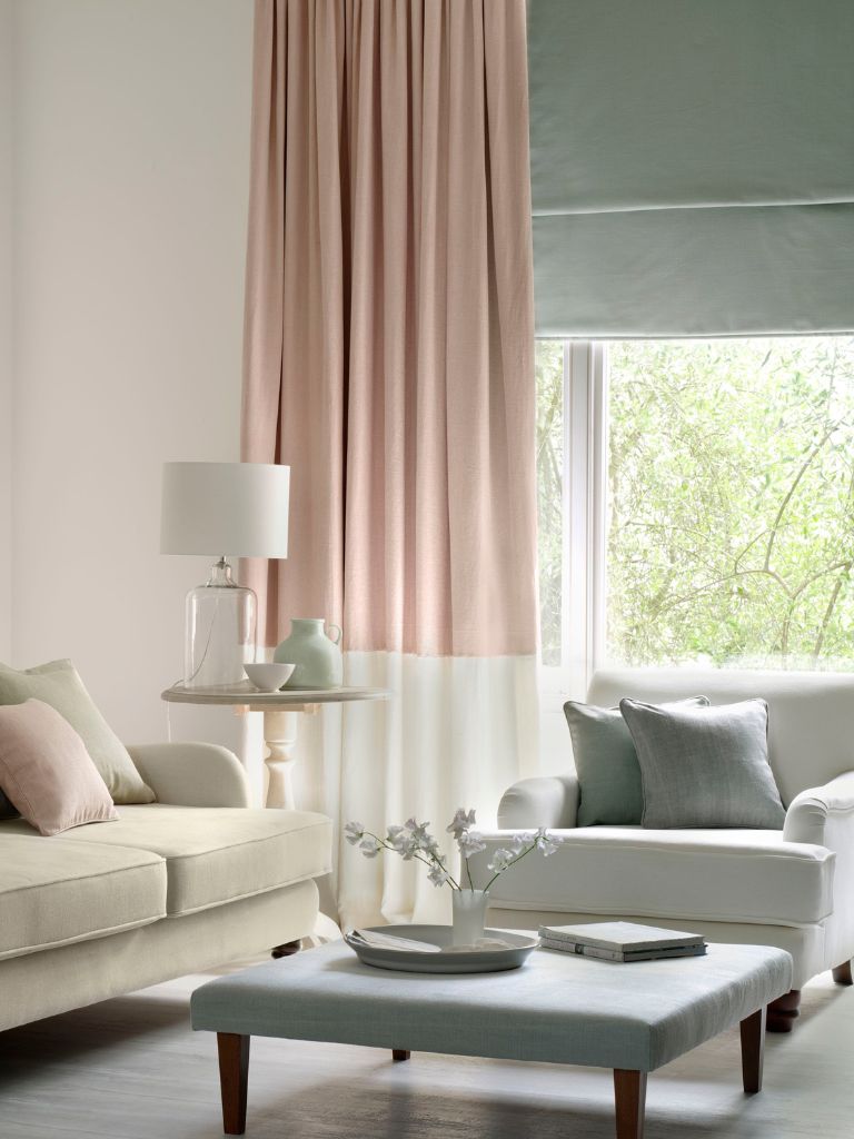 A pink curtain with a green Roman blinds
