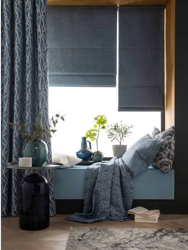 A comfortcore relaxation space with blue curtains and Roman blinds
