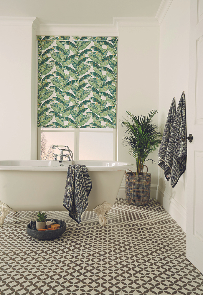 A quality plant inspired roller blinds in a classic bathroom with free standing bath and plant.  