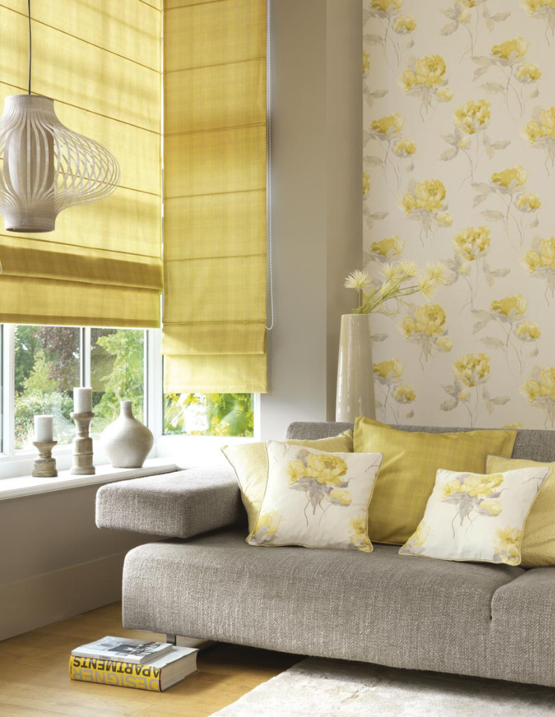 A chintz inspired yellow living room with Roman blinds, cushions and a comfy sofa. 