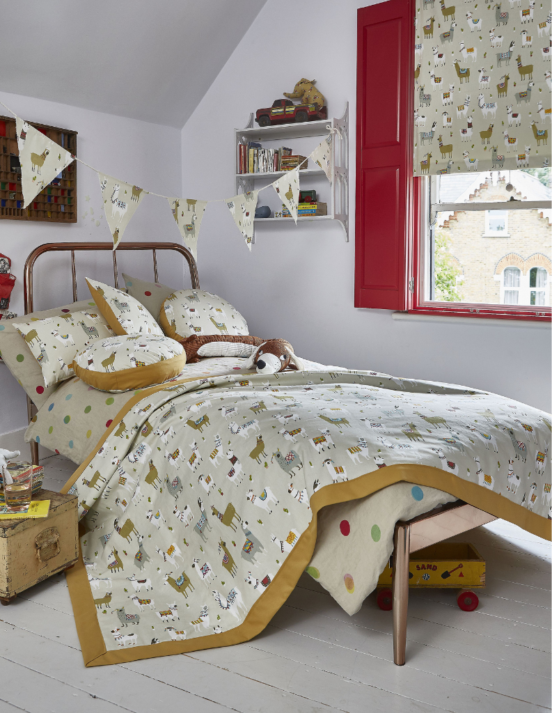 A colourful child's bedroom with animal patterned Roman blinds and bedding.