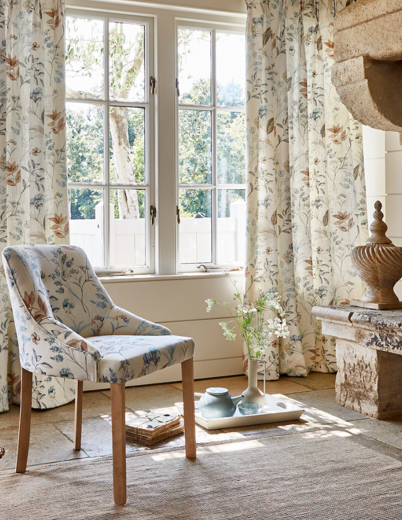 Floral curtains and chair in a heritage inspired living room. 