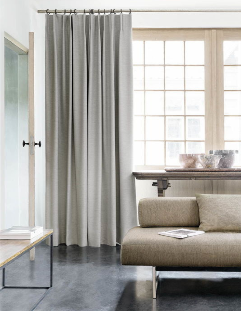 A refined living room with a lovely grey curtains and neutral furnishings.