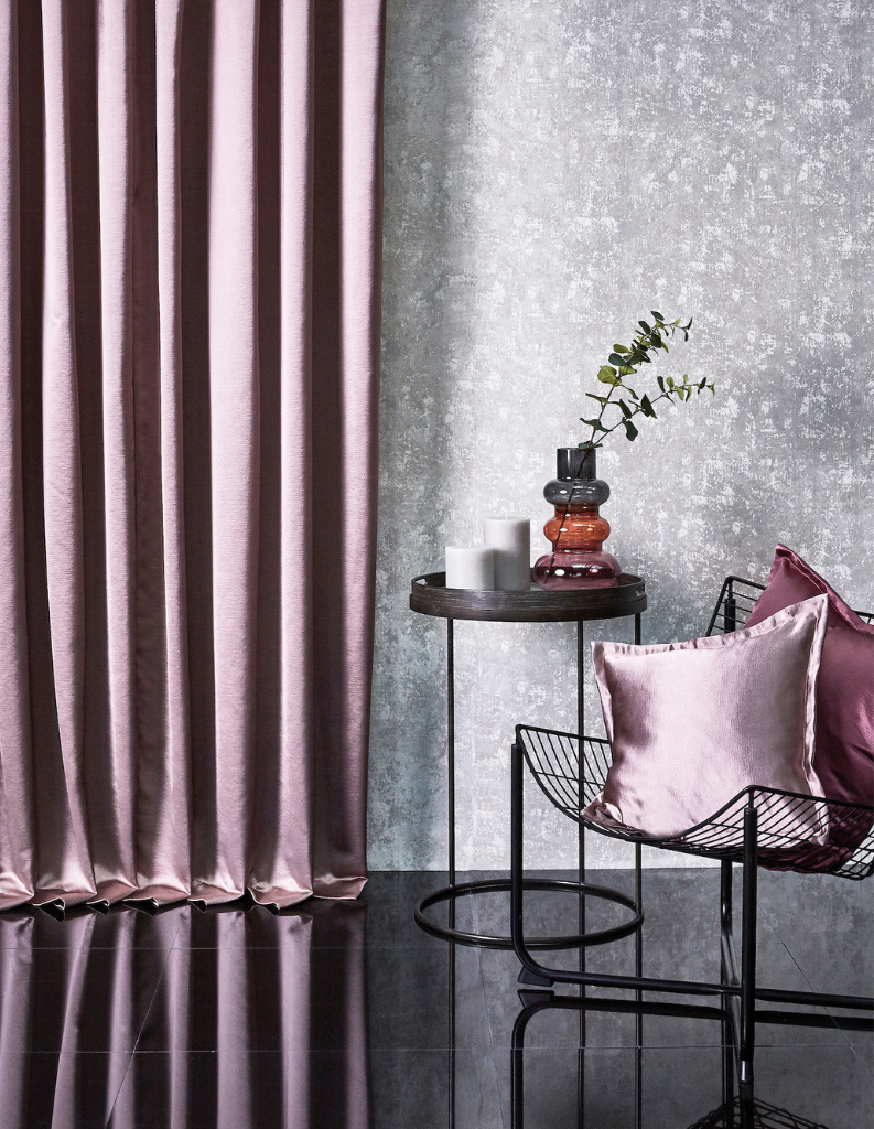 Stylish lilac curtains and cushions in a grey living room. 