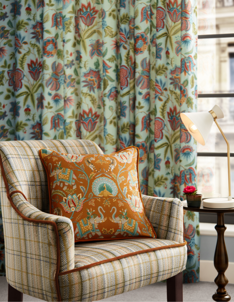 Armchair with cushion in living room with curtains.