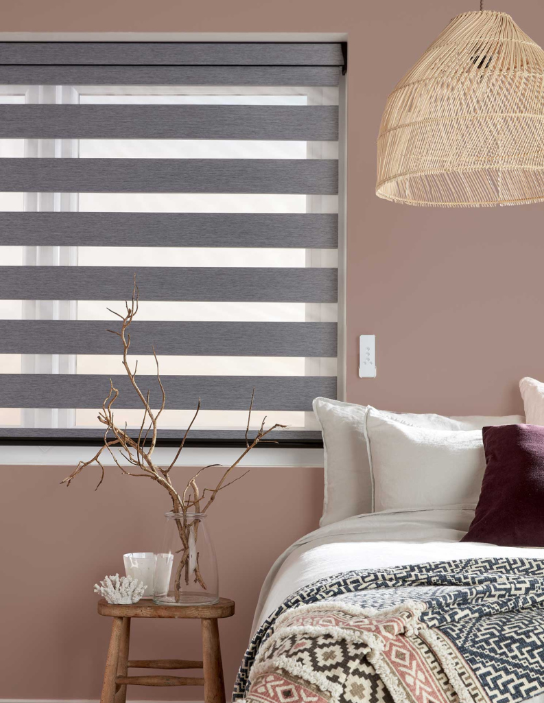 Grey day and night blinds in bedroom.