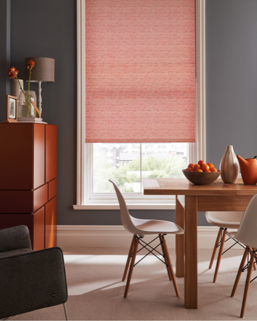 Pink roller blinds in dining room.