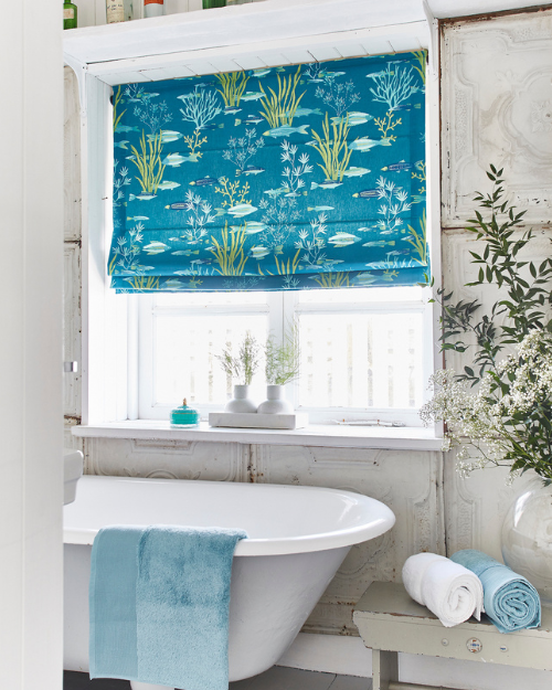 Roman blind in bathroom with bathtub.