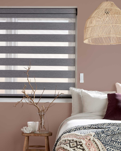Grey day and night blinds in bedroom.