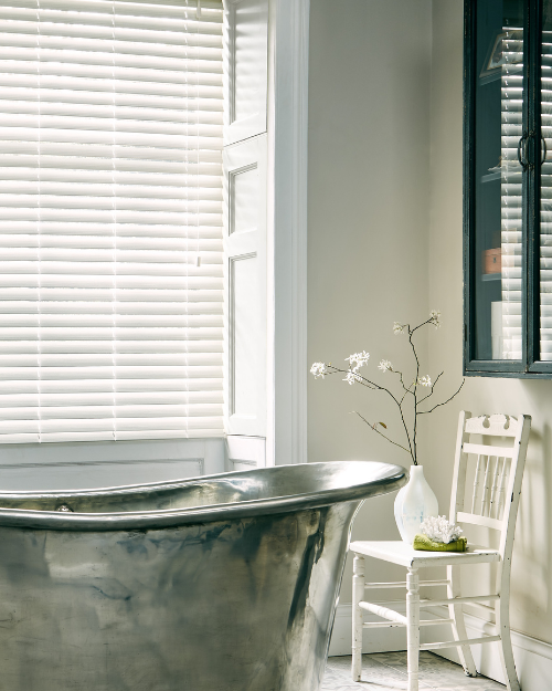 White faux wooden blinds in bathroom.