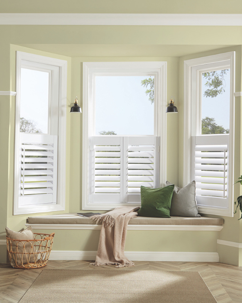 White shutter blinds in bay window.