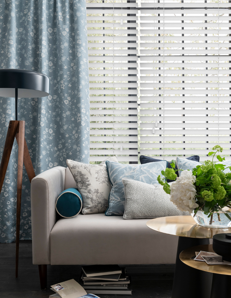Venetian blinds in living room with curtains.