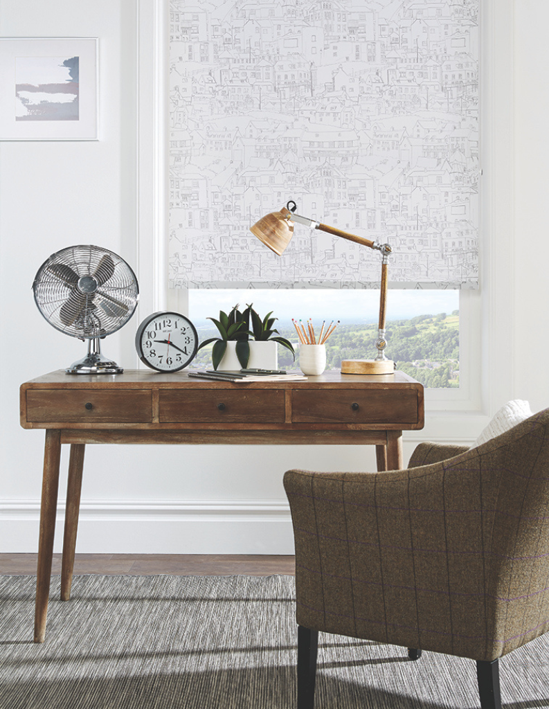 White roman blind in home office.